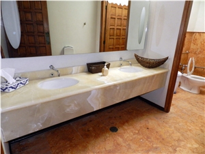 Baja Onyx Bathroomm Countertop and Ticul Naranja Limestone Flooring