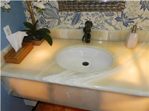 Baja Onyx Bathroomm Countertop and Ticul Naranja Limestone Flooring