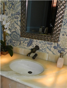 Baja Onyx Bathroomm Countertop and Ticul Naranja Limestone Flooring
