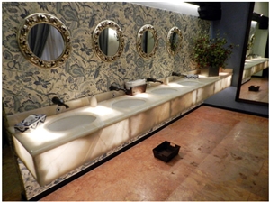 Baja Onyx Bathroomm Countertop and Ticul Naranja Limestone Flooring