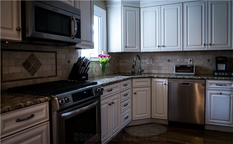 Amber Yellow Granite with Chiaro Travertine with Noce Travertine Pencil Backsplash.
