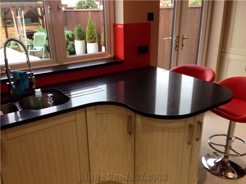 Red Glass Splashback on Black Sparkling Quartz Countertop