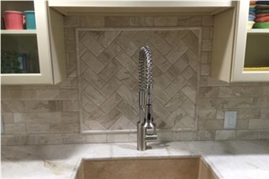 Quartzite Countertops Are Complimented with Beveled Marble Tiles in the Backsplash