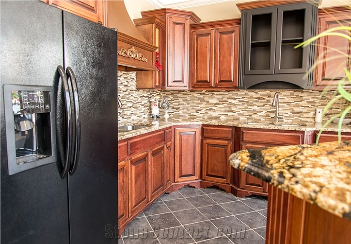 Kitchen Island with Golden Crystal Granite Paired with Stone Radiance Tile Backsplash, Ornamental Granite Countertops and Saddle Brown Cabinets