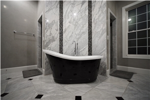 Bathroom Accent Wall Using Super White Quartzite to Tie the Countertops and Room Together