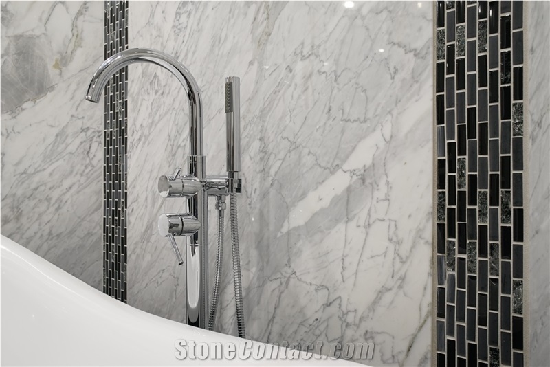 Bathroom Accent Wall Using Super White Quartzite to Tie the Countertops and Room Together