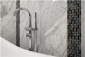Bathroom Accent Wall Using Super White Quartzite to Tie the Countertops and Room Together