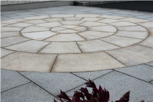 Gold Granite Circle with Black Limestone Paving