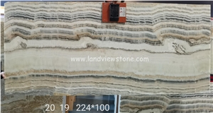 Light through Beige Wooden Veins Onyx Slab