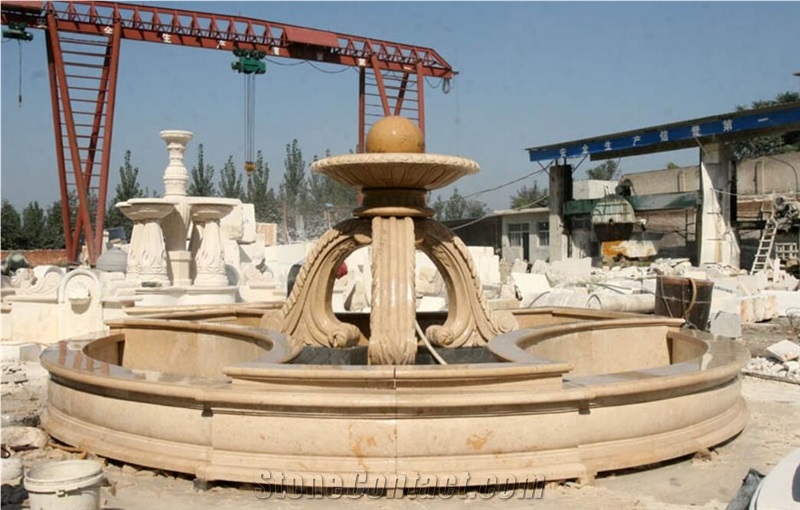 sculptured yellow limestone rolling sphere garden fountain