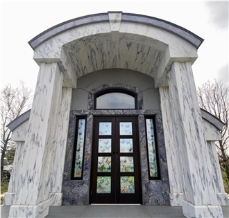 Monumental Memorial Featuring A Romanesque Style Arch