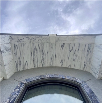 Monumental Memorial Featuring A Romanesque Style Arch