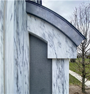 Monumental Memorial Featuring A Romanesque Style Arch