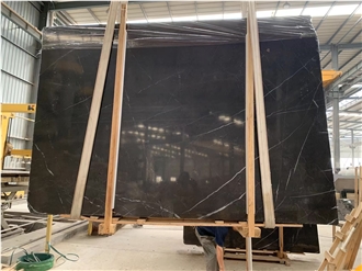 Pietra Grey Marble Tiles Exhibiting Light Gray Speckles